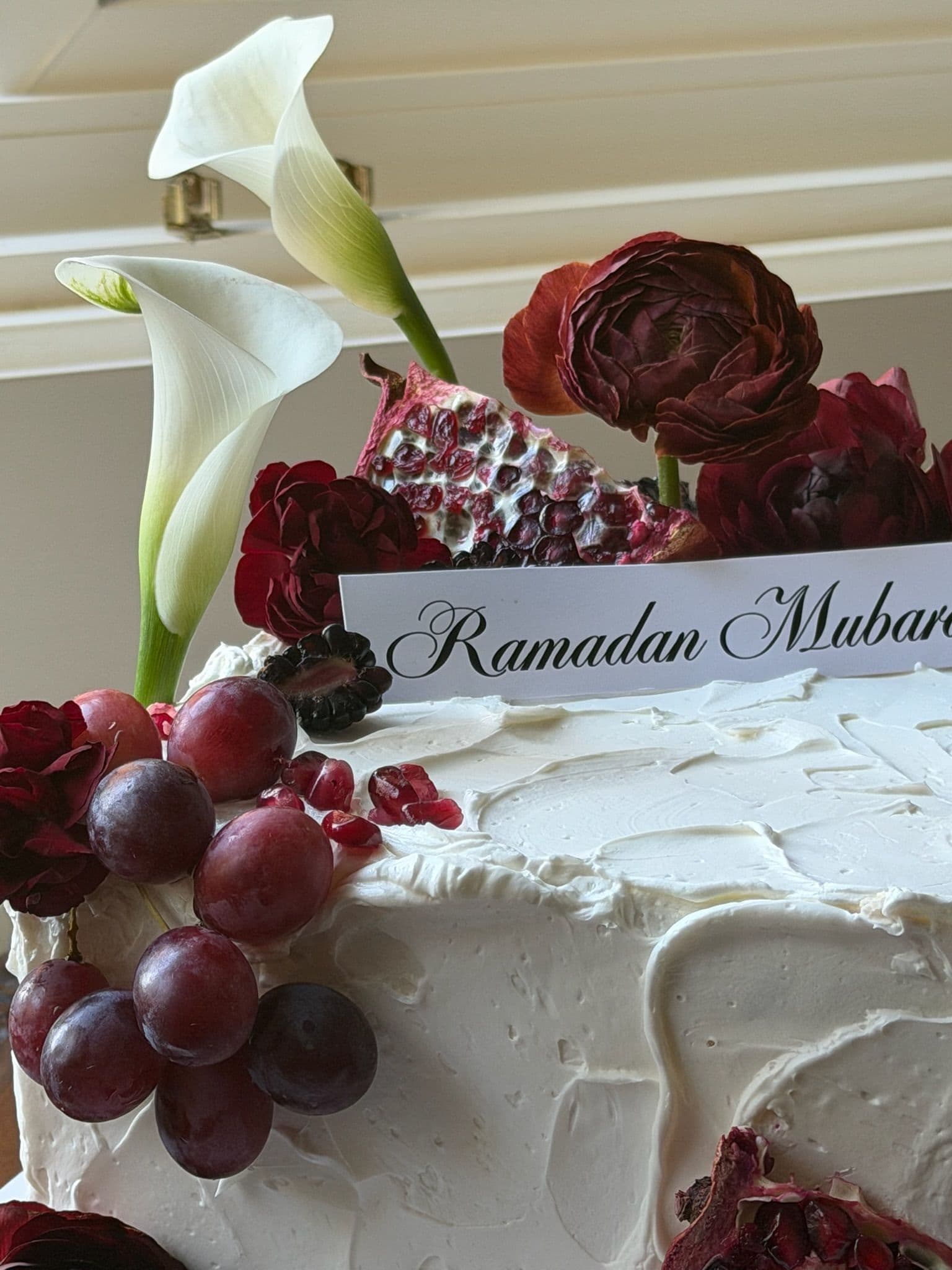 Textured buttercream cake with a Ramadan Mubarak plaque, red grapes and deep red roses